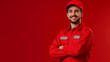 © Synthesia Studio - Smiling young man in a red uniform and cap with arms crossed