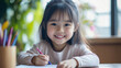 © Keitma - Portrait of a young Asian Japanese girl kid sitting at the dining table doing homework, math problems with a smile