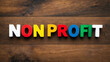 © Erlinda - non profit word colorful wooden letters on plain white background