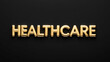 © Erlinda - healthcare word gold metallic shiny lettering on plain black background