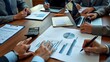 © Din Nasahrudin - A collaborative meeting featuring professionals analyzing financial reports and data on various devices, illustrating teamwork in business strategy and decision-making.