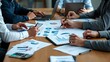 © Din Nasahrudin - A collaborative meeting featuring professionals analyzing financial reports and data on various devices, illustrating teamwork in business strategy and decision-making.