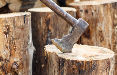 An axe stuck into a log. Close-up