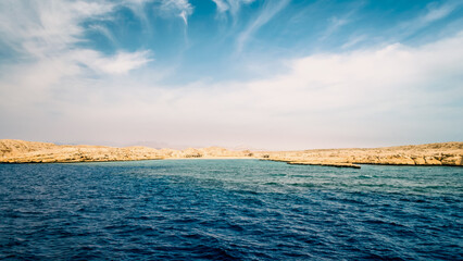 rocky coast of the Red Sea and.blue sky with clouds