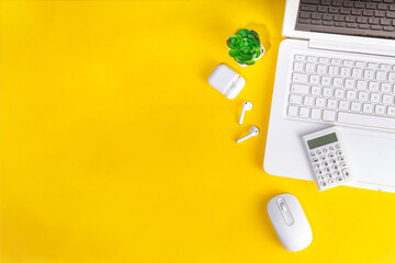Stylish right yellow minimalistic workplace with notebook