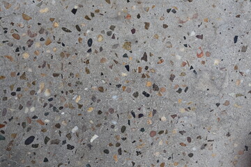 Close-up of polished concrete with various aggregate particles embedded in the surface