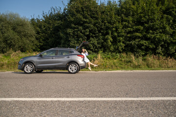 Wall Mural - Woman Relaxing on SUV in Nature