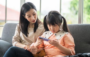 Portrait of enjoy happy love asian family mature mother and girl daughter smiling play and having fun together, mom, mother day, care, kid, child.happy family in moments good time at home