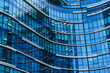 © ADDICTIVE STOCK - Close-up of blue glass facade in modern curved building