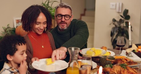 Wall Mural - Food, happy family and serving dinner for thanksgiving celebration in home at night. Child, mom and dad share meal, corn or eating healthy vegetables in plate with interracial people bonding together