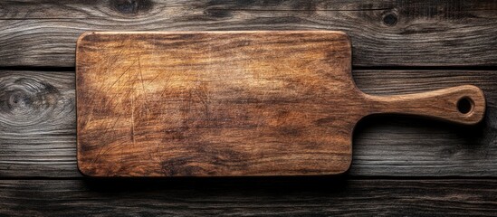 Poster - Wood cutting board placed on a wooden surface with copy space