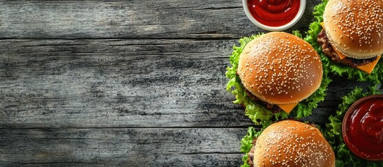Poster - Delicious homemade burgers topped with lettuce ketchup cheese and chicken on a gray wooden surface Copyspace