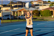 © Austockphoto - 10 year old girl about to catch netball on netball court