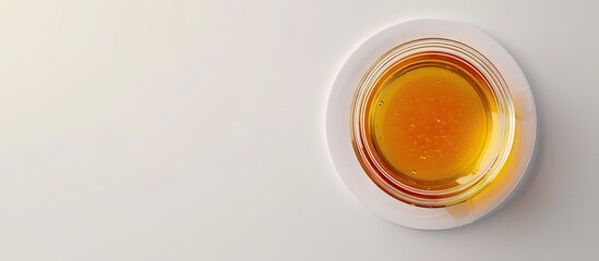 Poster - Honey jar with a wooden dipper on a white background top view with copy space Tasty bottle of honey