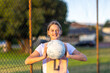 © Austockphoto - schoolgirl holding netball in throwing position