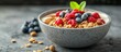 © vxnaghiyev - Chia pudding topped with homemade coconut granola peanut butter and berries in a gray bowl A healthy plant based diet detox summer recipe Breakfast served in the restaurant. with copy space image