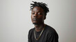 © AnniePatt - Black man with short hair, wearing a plain, solid black T-shirt and gold chain necklaces against a white background