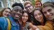 © Yulia - A group of multiethnic friends taking a selfie together.