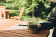 © ADDICTIVE STOCK - Teenage girl enjoying a cool matcha drink outdoors