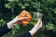 © ADDICTIVE STOCK - Teenager holding croissant and iced matcha drink outdoors