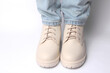 © splitov27 - Female legs in jeans and white leather boots on white background. Fashion concept