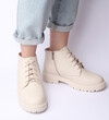 © splitov27 - Female legs in jeans and white leather boots on white background. Fashion concept