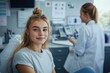 © PremiumPhoto - A young woman smiling while using a telehealth service on her laptop at home, showcasing the convenience and accessibility of remote healthcare options.