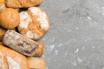 Wall Mural - Homemade natural breads. Different kinds of fresh bread as background, top view with copy space