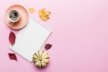Wall Mural - autumn composition: fallen leaves and notebook mock up on colored background. top view. flat lay wit