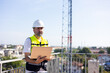 © NVB Stocker - communication pole. Communications engineer checking internet signal on laptop computer at transmitter station. Product quality Inspection