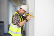 © NVB Stocker - Yellow tape measure construction tools. Engineering, construction site. Architect worker working at house construction site