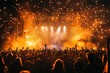 © khalid_spk - An electrifying image of a large outdoor concert with a crowd of people facing a stage illuminated