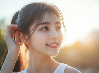 Poster - Beautiful Korean woman with closed eyes, touching her hair in bright sunlight, wearing a tank top.