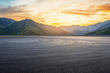 Empty asphalt road and beautiful mountain nature landscape at sunset. High quality photo