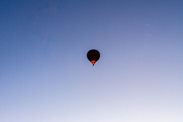 Hot air balloons rise before the sun rises