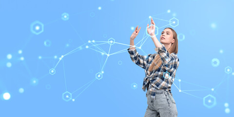 Fototapete - Woman interacting with futuristic digital interface on blue background.