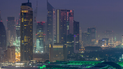 Dubai Downtown night to day timelapse. Aerial view over big futuristic city by night.