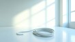 © Benjawan - Single jump rope coiled on a clean white floor, minimalistic and soft natural light, extensive empty space for text, No logo, No Trademark, No text