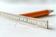 © Benjawan - Single ruler and pencil on a white desk, minimalistic and clean, soft morning light, abundant empty space for text, No logo, No Trademark, No text