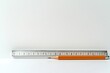 © Benjawan - Single ruler and pencil on a white desk, minimalistic and clean, soft morning light, abundant empty space for text, No logo, No Trademark, No text