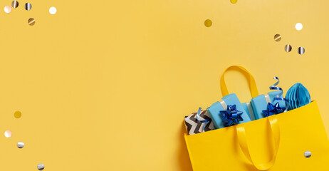 Wall Mural - Yellow package with Christmas gifts. Festive flatlay with place for text