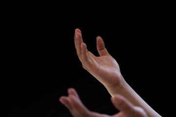 Close-up of two hands showing supplication or prayer. Photo isolated on black background