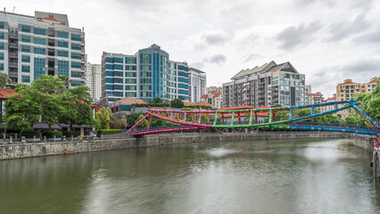 Alkaff Bridge on the Singapore River at Robertson Quay with dark gray clouds timelapse hyperlapse