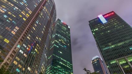 Looking up perspective of modern business skyscrapers glass and sky view landscape of commercial building in central city timelapse hyperlapse