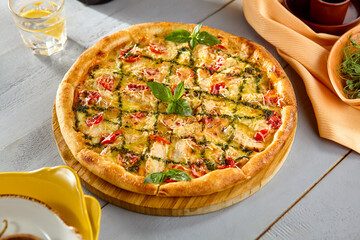 Freshly Baked Chicken Pesto Pizza with Crispy Crust and Basil Garnish