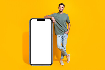 Aufkleber - Full length photo of dreamy good mood guy wear khaki t-shirt texting modern device empty space isolated yellow color background