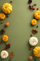 Wall Mural - A vibrant vertical autumn-themed background featuring a variety of pumpkins, colorful leaves, acorns, and berries on a green surface. Perfect for seasonal and Thanksgiving designs