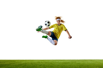 Wall Mural - Young female soccer player, mid-20s, airborne and fully extended, delivering powerful strike at ball, emphasizing strength and skill. Concept of sport, competition, tournament, games, event.