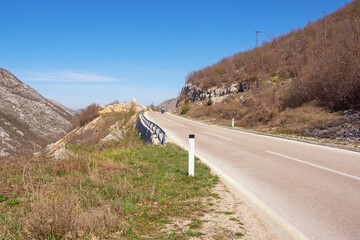 Balkan road trip. Sunny mountain landscape with road in Dinaric Alps. Bosnia and Herzegovina, Republika Srpska