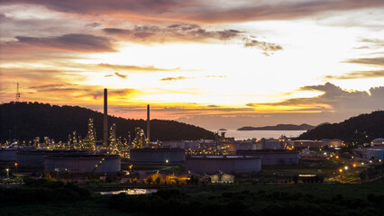 Wall Mural - Oil Refinery plant at sunset. Gas Chemical Equipment Prodiction import export Concept, Crude Oil Refinery Plant Steel Pump Pipe line and Chimney and Cooling tower, Chemical Petrochemical